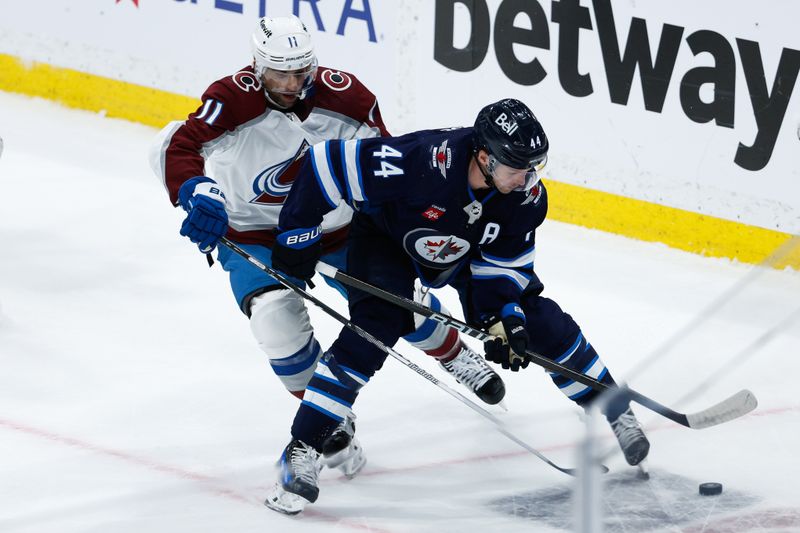 Apr 23, 2024; Winnipeg, Manitoba, CAN; Winnipeg Jets defenseman Josh Morrissey (44) shields the puck from Colorado Avalanche forward Andrew Cogliano (11) during the third period in game two of the first round of the 2024 Stanley Cup Playoffs at Canada Life Centre. Mandatory Credit: Terrence Lee-USA TODAY Sports