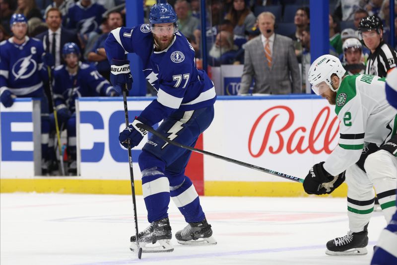 Dec 4, 2023; Tampa, Florida, USA;Tampa Bay Lightning defenseman Victor Hedman (77) passes the puck against the Dallas Stars during the first period at Amalie Arena. Mandatory Credit: Kim Klement Neitzel-USA TODAY Sports