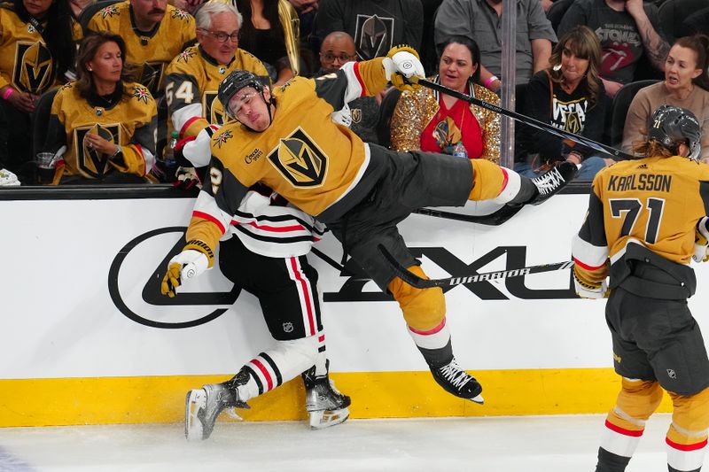 Apr 16, 2024; Las Vegas, Nevada, USA; Vegas Golden Knights defenseman Zach Whitecloud (2) checks Chicago Blackhawks center Frank Nazar (91) during the second period at T-Mobile Arena. Mandatory Credit: Stephen R. Sylvanie-USA TODAY Sports