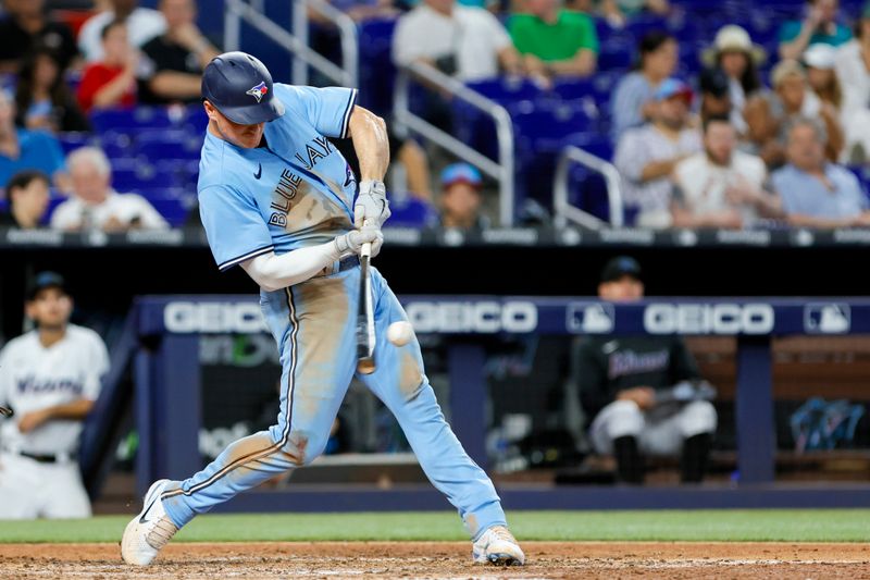 Jun 21, 2023; Miami, Florida, USA; Toronto Blue Jays third baseman Matt Chapman (26) hits a home run against the Miami Marlins during the eighth inning at loanDepot Park. Mandatory Credit: Sam Navarro-USA TODAY Sports