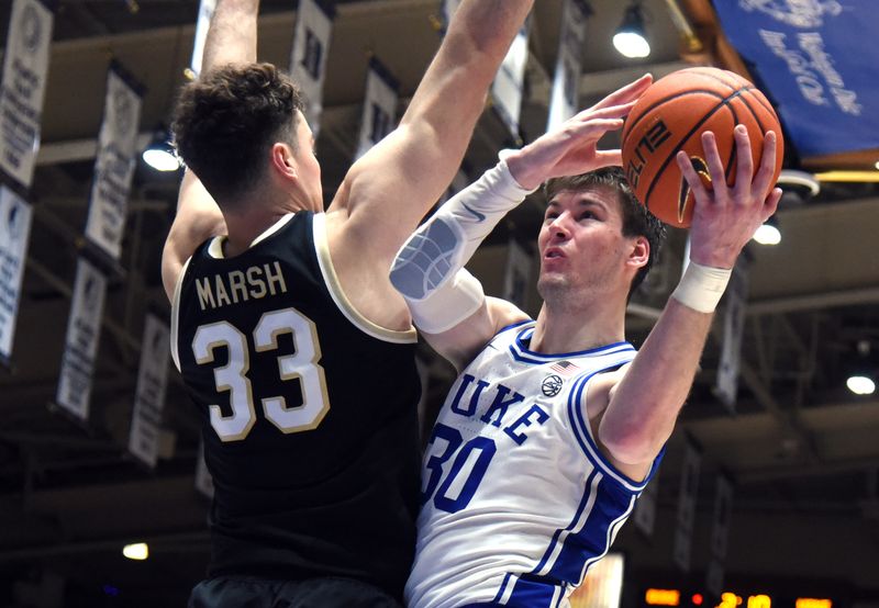 Feb 12, 2024; Durham, North Carolina, USA; Duke Blue Devils center Kyle Filipowski (30) shoots over Wake Forest Deamon Deacons center Matthew Marsh (33) during the second half at Cameron Indoor Stadium. The Blue Devils won 77-69. Mandatory Credit: Rob Kinnan-USA TODAY Sports