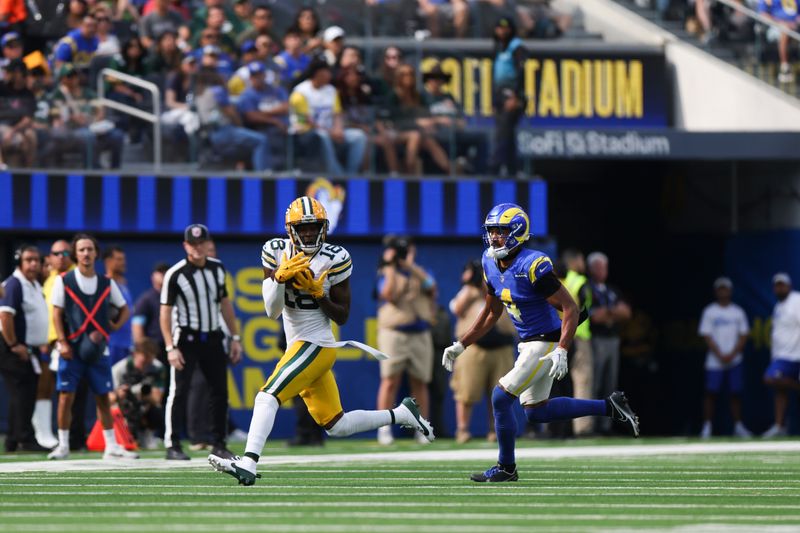 Green Bay Packers wide receiver Malik Heath (18) makes a catch against Los Angeles Rams cornerback Ahkello Witherspoon (4) during the first half of an NFL football game Sunday, Oct. 6, 2024, in Inglewood, Calif. (AP Photo/Ryan Sun)