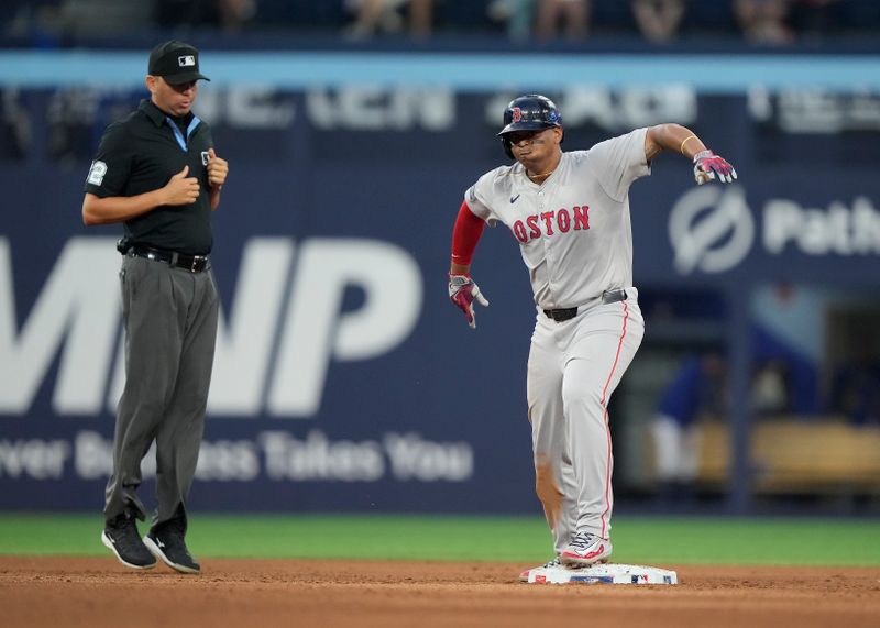 Jun 18, 2024; Toronto, Ontario, CAN; Boston Red Sox third baseman Rafael Devers (11) celebrates his double against the Toronto Blue Jays during the sixth inning at Rogers Centre. Mandatory Credit: John E. Sokolowski-USA TODAY Sports