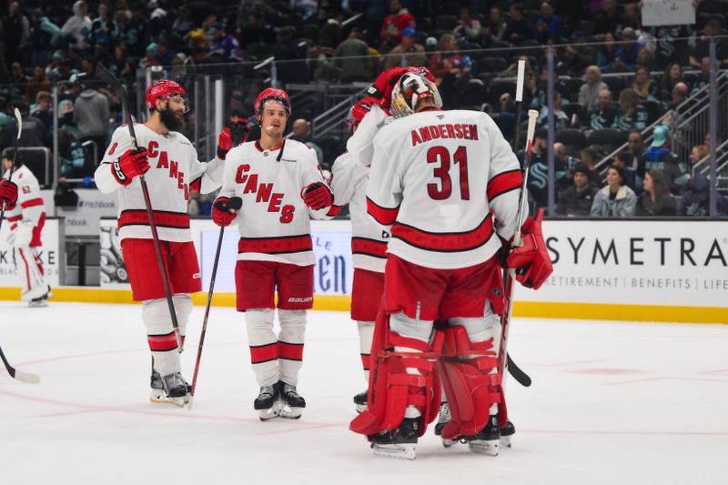 Oct 26, 2024; Seattle, Washington, USA; The Carolina Hurricanes celebrate defeating the Seattle Kraken at Climate Pledge Arena. Mandatory Credit: Steven Bisig-Imagn Images