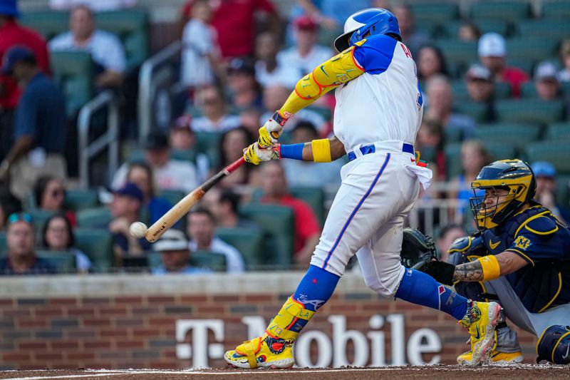 Jul 29, 2023; Cumberland, Georgia, USA; Atlanta Braves right fielder Ronald Acuna Jr. (13) hits a single against the Milwaukee Brewers during the first inning at Truist Park. Mandatory Credit: Dale Zanine-USA TODAY Sports