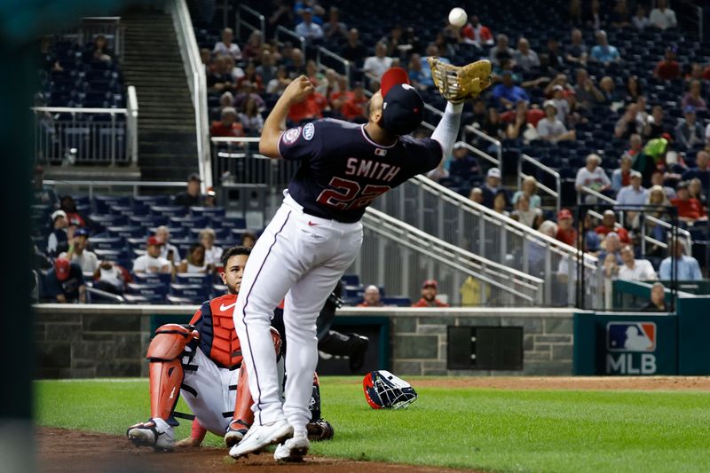 Sep 18, 2023; Washington, District of Columbia, USA; Washington Nationals catcher Keibert Ruiz (20) watches as Washington Nationals first baseman Dominic Smith (22) catches a pop up hit by Chicago White Sox designated hitter Eloy Jimenez (not pictured) during the fourth inning at Nationals Park. Mandatory Credit: Geoff Burke-USA TODAY Sports