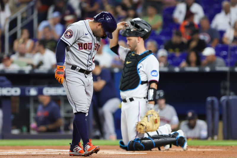 Aug 15, 2023; Miami, Florida, USA; Houston Astros second baseman Jose Altuve (27) reacts after fouling a pitch off his shin against the Miami Marlins during the first inning at loanDepot Park. Mandatory Credit: Sam Navarro-USA TODAY Sports