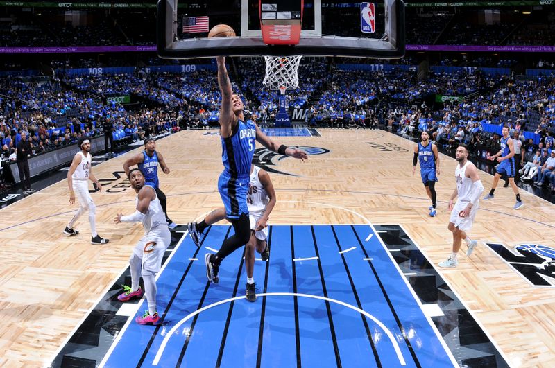 ORLANDO, FL - APRIL 27: Paolo Banchero #5 of the Orlando Magic drives to the basket during the game against the Cleveland Cavaliers during Round 1 Game 4 of the 2024 NBA Playoffs on April 27, 2024 at the Kia Center in Orlando, Florida. NOTE TO USER: User expressly acknowledges and agrees that, by downloading and or using this photograph, User is consenting to the terms and conditions of the Getty Images License Agreement. Mandatory Copyright Notice: Copyright 2024 NBAE (Photo by Fernando Medina/NBAE via Getty Images)