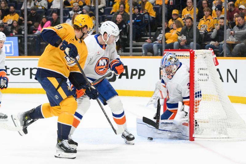 Apr 8, 2025; Nashville, Tennessee, USA;  New York Islanders goaltender Ilya Sorokin (30) blocks the shot of Nashville Predators left wing Jakub Vrana (19) during the first period at Bridgestone Arena. Mandatory Credit: Steve Roberts-Imagn Images