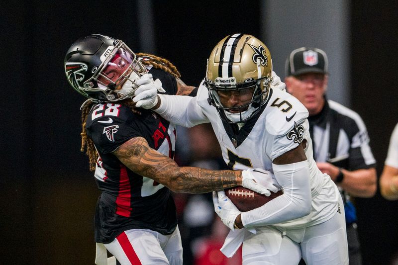 New Orleans Saints wide receiver Jarvis Landry (5) stiff arms Atlanta Falcons cornerback Mike Ford (28) during the first half of an NFL football game, Sunday, Sep. 11, 2022, in Atlanta. (AP Photo/Danny Karnik)