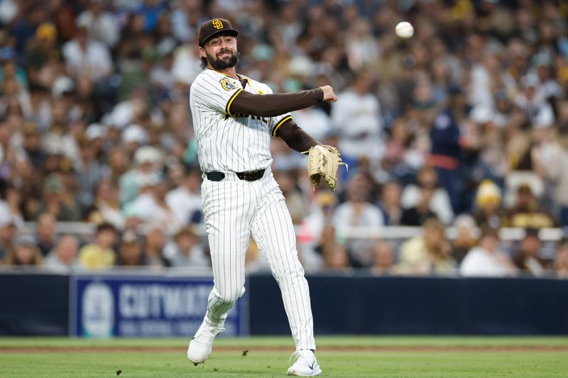 May 28, 2024; San Diego, California, USA; San Diego Padres starting pitcher Matt Waldron (61) fields the ball and throws to first for the out during the fifth inning against the Miami Marlins at Petco Park. Mandatory Credit: David Frerker-USA TODAY Sports