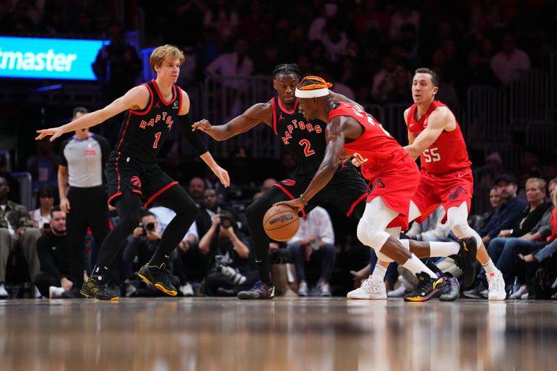 MIAMI, FLORIDA - DECEMBER 12: Jimmy Butler #22 of the Miami Heat dribbles the ball against Jonathan Mogbo #2 of the Toronto Raptors during the third quarter at Kaseya Center on December 12, 2024 in Miami, Florida. NOTE TO USER: User expressly acknowledges and agrees that, by downloading and or using this Photograph, user is consenting to the terms and conditions of the Getty Images License Agreement. (Photo by Rich Storry/Getty Images)