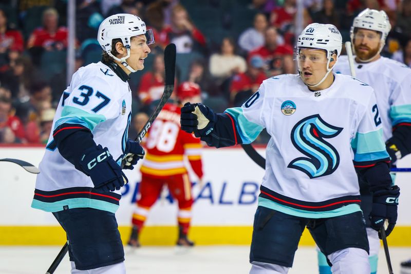 Mar 4, 2024; Calgary, Alberta, CAN; Seattle Kraken center Yanni Gourde (37) celebrates his goal with teammates against the Calgary Flames during the first period at Scotiabank Saddledome. Mandatory Credit: Sergei Belski-USA TODAY Sports