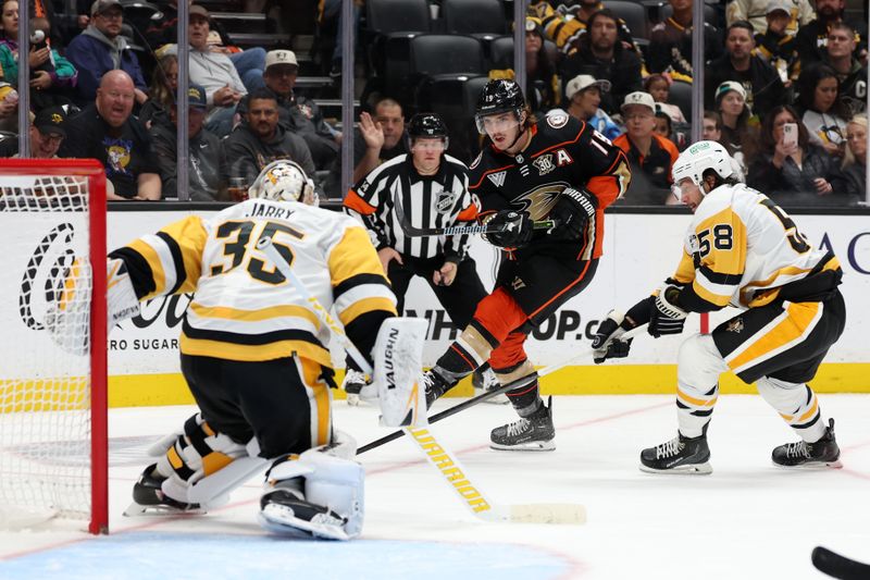 Nov 7, 2023; Anaheim, California, USA; Anaheim Ducks right wing Troy Terry (19) shoots the puck against Pittsburgh Penguins goaltender Tristan Jarry (35) during the second period at Honda Center. Mandatory Credit: Kiyoshi Mio-USA TODAY Sports