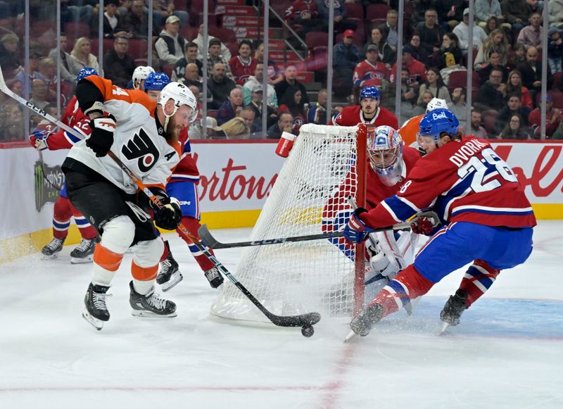 Sep 23, 2024; Montreal, Quebec, CAN; Philadelphia Flyers forward Nicolas Deslauriers (44) plays the puck and Montreal Canadiens forward Christian Dvorak (28) defends during the first period at the Bell Centre. Mandatory Credit: Eric Bolte-Imagn Images