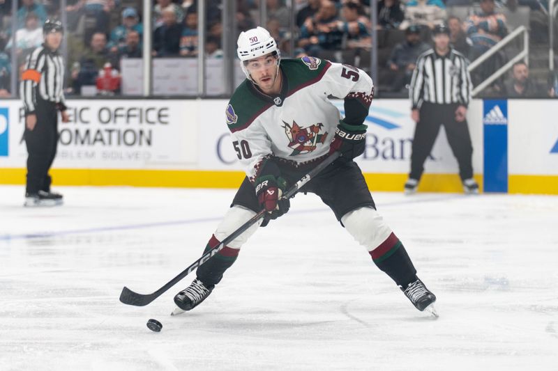 Dec 21, 2023; San Jose, California, USA; Arizona Coyotes defenseman Sean Durzi (50) looks to pass the puck during the third period against the San Jose Sharks at SAP Center at San Jose. Mandatory Credit: Stan Szeto-USA TODAY Sports