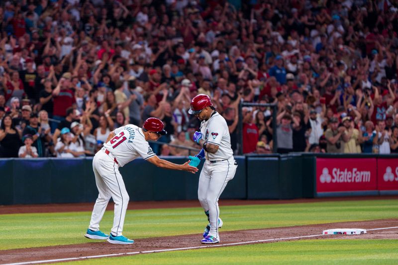 Aug 10, 2024; Phoenix, Arizona, USA; Arizona Diamondbacks infielder Ketel Marte (4) celebrates with 3rd base coach Tony Perezchica (21) after hitting a home run in the first inning against the Philadelphia Phillies at Chase Field. Mandatory Credit: Allan Henry-USA TODAY Sports