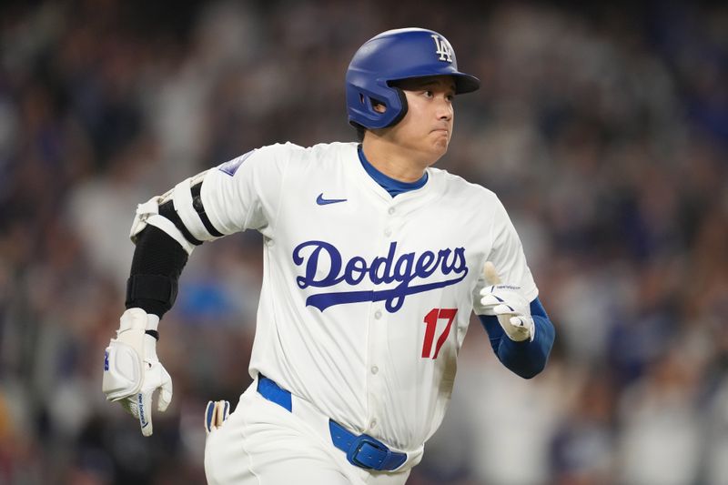 Sep 25, 2024; Los Angeles, California, USA;  Los Angeles Dodgers designated hitter Shohei Ohtani (17) hits an RBI double in the fourth inning against the San Diego Padres at Dodger Stadium. Mandatory Credit: Kirby Lee-Imagn Images