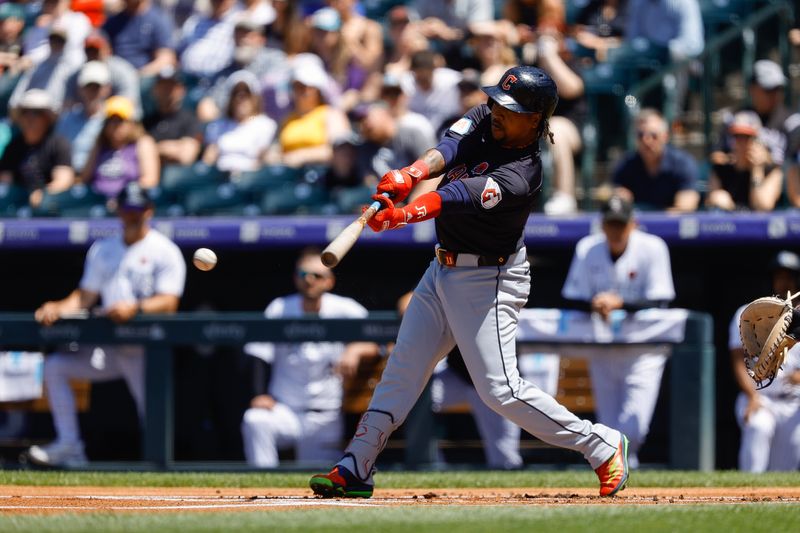 May 27, 2024; Denver, Colorado, USA; Cleveland Guardians third baseman Jose Ramirez (11) hits a sacrifice RBI in the first inning against the Colorado Rockies at Coors Field. Mandatory Credit: Isaiah J. Downing-USA TODAY Sports