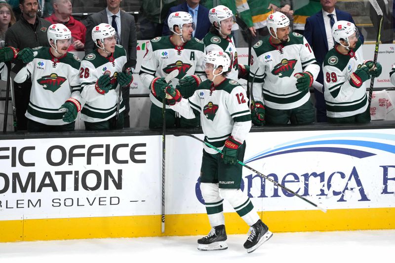 Mar 11, 2023; San Jose, California, USA; Minnesota Wild left wing Matt Boldy (12) is congratulated by teammates after scoring a goal against the San Jose Sharks during the third period at SAP Center at San Jose. Mandatory Credit: Darren Yamashita-USA TODAY Sports