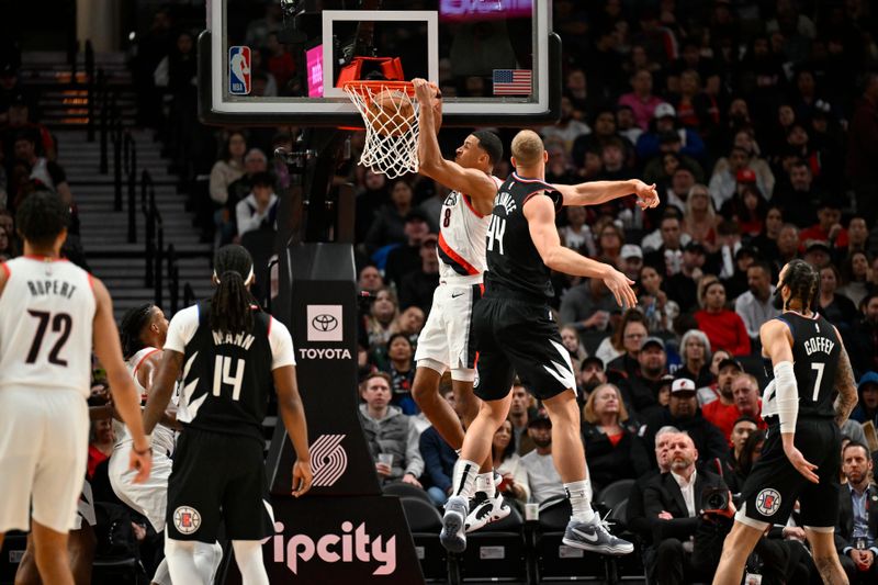 PORTLAND, OREGON - MARCH 22: Kris Murray #8 of the Portland Trail Blazers dunks over Mason Plumlee #44 of the LA Clippers during the fourth quarter of the game at the Moda Center on March 22, 2024 in Portland, Oregon. The LA Clippers won 125-117. NOTE TO USER: User expressly acknowledges and agrees that, by downloading and or using this photograph, User is consenting to the terms and conditions of the Getty Images License Agreement. (Photo by Alika Jenner/Getty Images)