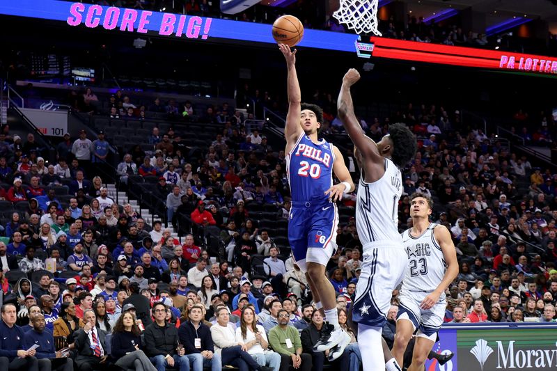 PHILADELPHIA, PENNSYLVANIA - DECEMBER 04: Jared McCain #20 of the Philadelphia 76ers goes in for a layup against Jonathan Isaac #1 of the Orlando Magic during the first half at the Wells Fargo Center on December 04, 2024 in Philadelphia, Pennsylvania. NOTE TO USER: User expressly acknowledges and agrees that, by downloading and or using this photograph, User is consenting to the terms and conditions of the Getty Images License Agreement. (Photo by Emilee Chinn/Getty Images)