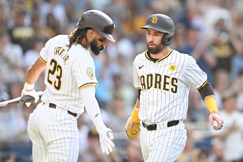 Sep 2, 2024; San Diego, California, USA; San Diego Padres shortstop Mason McCoy (18), right, is congratulated by  Fernando Tatis Jr. (23) after scoring during the third inning against the Detroit Tigers at Petco Park. Mandatory Credit: Denis Poroy-USA TODAY Sports