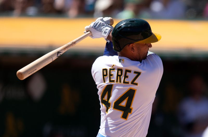 Jun 18, 2023; Oakland, California, USA; Oakland Athletics pinch hitter Carlos Perez (44) follows through on his RBI single against the Philadelphia Phillies during the inning at Oakland-Alameda County Coliseum. Mandatory Credit: D. Ross Cameron-USA TODAY Sports