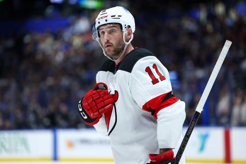 Nov 16, 2024; Tampa, Florida, USA; New Jersey Devils right wing Stefan Noesen (11) looks on against the Tampa Bay Lightning in the second period at Amalie Arena. Mandatory Credit: Nathan Ray Seebeck-Imagn Images