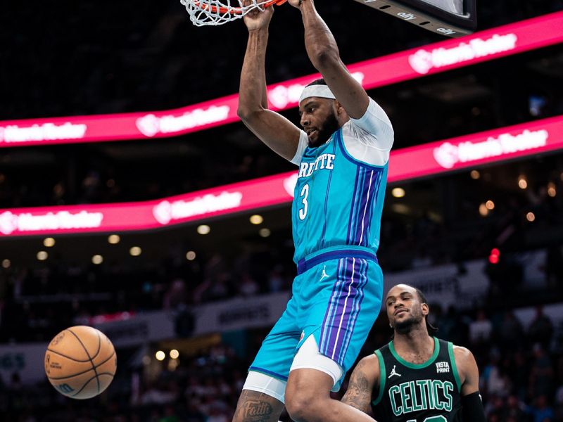 CHARLOTTE, NORTH CAROLINA - APRIL 01: Marques Bolden #3 of the Charlotte Hornets dunks the ball while guarded by Oshae Brissett #12 of the Boston Celtics in the first quarter during their game at Spectrum Center on April 01, 2024 in Charlotte, North Carolina. NOTE TO USER: User expressly acknowledges and agrees that, by downloading and or using this photograph, User is consenting to the terms and conditions of the Getty Images License Agreement. (Photo by Jacob Kupferman/Getty Images)