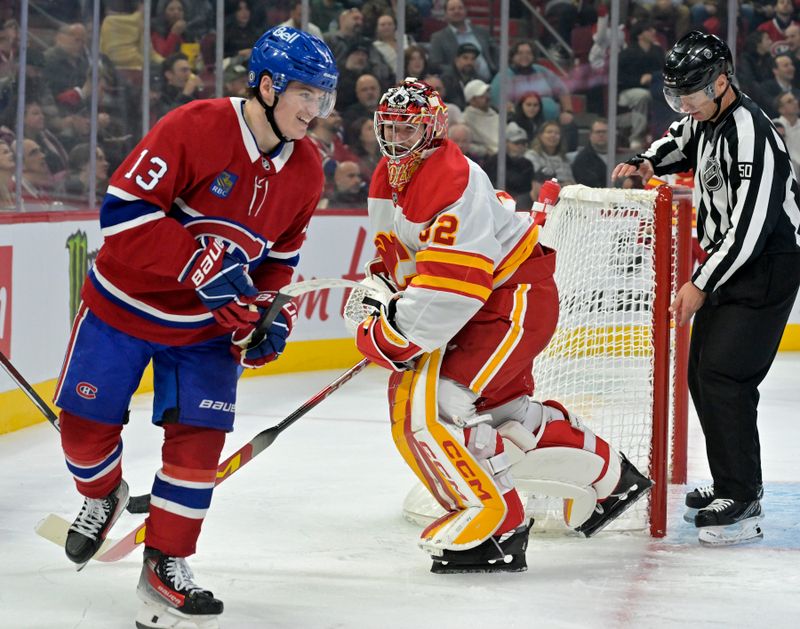 Nov 5, 2024; Montreal, Quebec, CAN; Montreal Canadiens forward Cole Caufield (13) and Calgary Flames goalie Dustin Wolf (32) exchange words during the second period at the Bell Centre. Mandatory Credit: Eric Bolte-Imagn Images