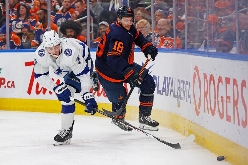 Dec 14, 2023; Edmonton, Alberta, CAN; Edmonton Oilers forward Zach Hyman (18) and Tampa Bay Lightning defensemen Hayden Fleury (7) battle along the boards for a loose puck during the third period at Rogers Place. Mandatory Credit: Perry Nelson-USA TODAY Sports