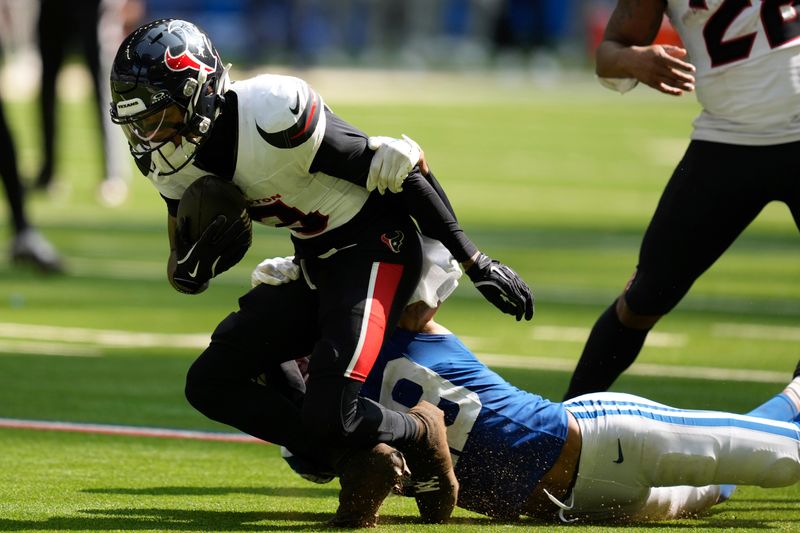 Indianapolis Colts cornerback JuJu Brents (29) tackles Houston Texans wide receiver Tank Dell (3) during the second half of an NFL football game, Sunday, Sept. 8, 2024, in Indianapolis. (AP Photo/Darron Cummings)