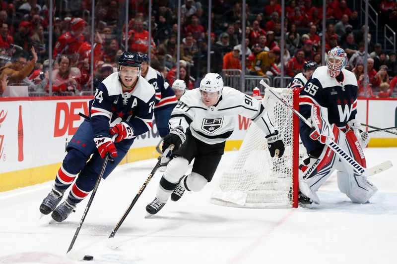 Jan 7, 2024; Washington, District of Columbia, USA; Washington Capitals defenseman John Carlson (74) skates with the puck past Los Angeles Kings right wing Carl Grundstrom (91) during the third period at Capital One Arena. Mandatory Credit: Amber Searls-USA TODAY Sports