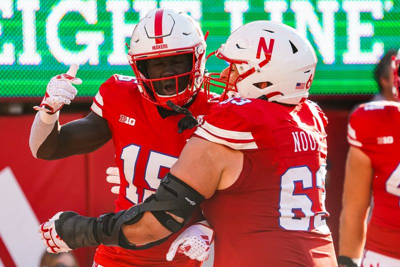 Oct 21, 2023; Lincoln, Nebraska, USA; Nebraska Cornhuskers wide receiver Malachi Coleman (15) and offensive lineman Nouredin Nouili (63) celebrate after a touchdown by Coleman against the Northwestern Wildcats during the fourth quarter at Memorial Stadium. Mandatory Credit: Dylan Widger-USA TODAY Sports