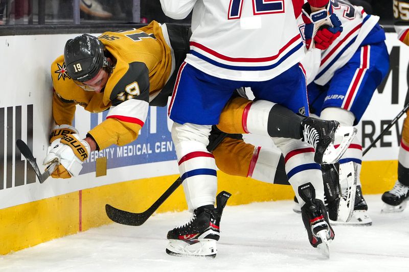 Nov 28, 2025; Las Vegas, Nevada, USA; Vegas Golden Knights right wing Reilly Smith (19) is checked by Montréal Canadiens defenseman Arber Xhekaj (72) during the third period at T-Mobile Arena. Mandatory Credit: Stephen R. Sylvanie-Imagn Images