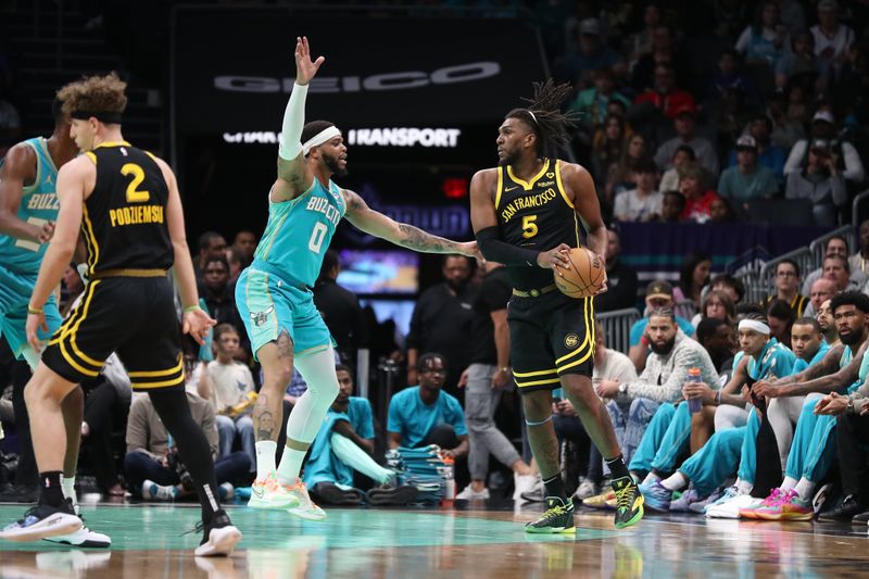 CHARLOTTE, NC - MARCH 29:  Kevon Looney #5 of the Golden State Warriors handles the ball during the game against the Charlotte Hornets on March 29, 2024 at Spectrum Center in Charlotte, North Carolina. NOTE TO USER: User expressly acknowledges and agrees that, by downloading and or using this photograph, User is consenting to the terms and conditions of the Getty Images License Agreement.  Mandatory Copyright Notice:  Copyright 2024 NBAE (Photo by Brock Williams-Smith/NBAE via Getty Images)