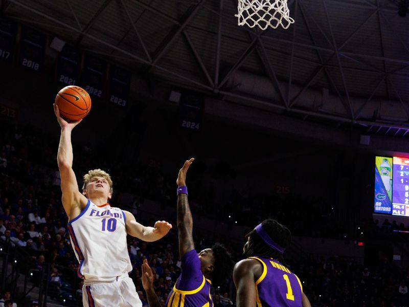Jan 20, 2026; Gainesville, Florida, USA; Florida Gators forward Thomas Haugh (10) shoots the ball over Louisiana State Tigers guard Rashad King (4) and  center Michael Nwoko (1) during the second half at Exactech Arena at the Stephen C. O'Connell Center. Mandatory Credit: Matt Pendleton-Imagn Images
