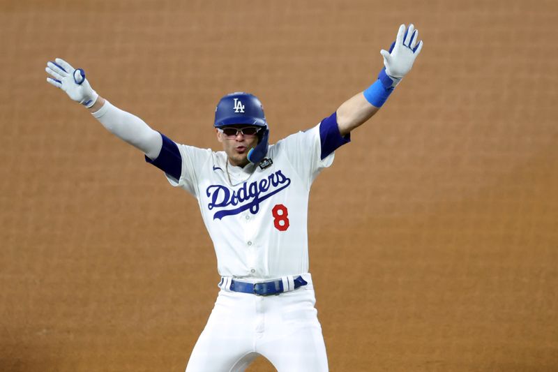 Oct 25, 2024; Los Angeles, California, USA; Los Angeles Dodgers outfielder Enrique Hernandez (8) celebrates at third base after hitting a triple in the fifth inning against the New York Yankees during game one of the 2024 MLB World Series at Dodger Stadium. Mandatory Credit: Kiyoshi Mio-Imagn Images