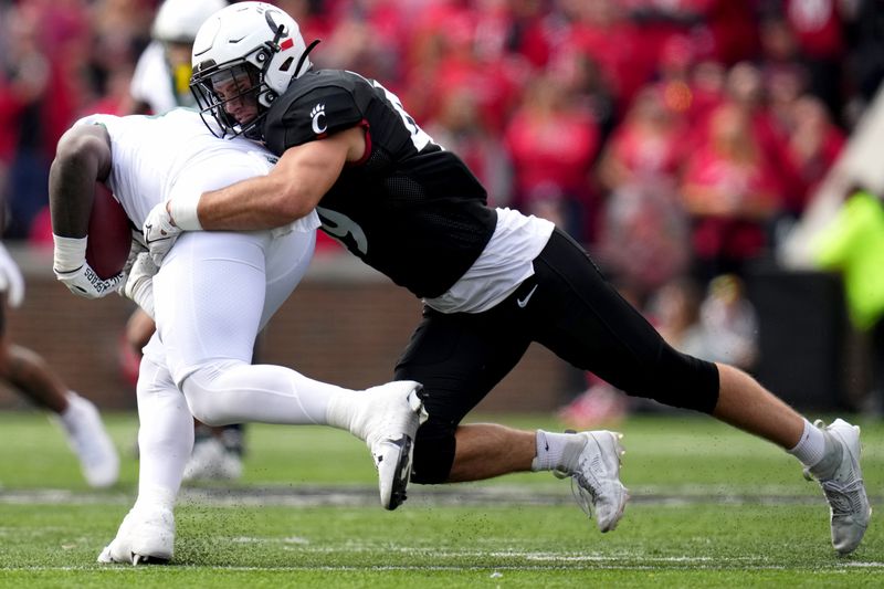 Oct 21, 2023; Cincinnati, Ohio, USA; Cincinnati Bearcats linebacker Jack Dingle (49) tackles Baylor Bears wide receiver Jonah Burton (17) in the second quarter at Nippert Stadium. Mandatory Credit: Kareem Elgazzar-USA TODAY Sports