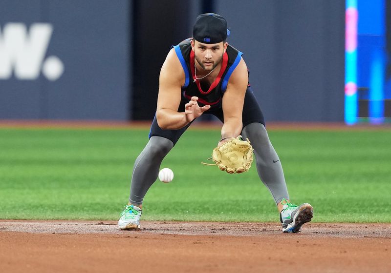 May 2, 2025; Toronto, Ontario, CAN; Toronto Blue Jays shortstop Bo Bichette (11) fields balls during batting practice before a game against the Cleveland Guardians at Rogers Centre. Mandatory Credit: Nick Turchiaro-Imagn Images