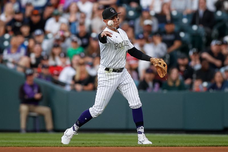 May 26, 2023; Denver, Colorado, USA; Colorado Rockies second baseman Alan Trejo (13) makes a throw to first for an out in the fourth inning against the New York Mets at Coors Field. Mandatory Credit: Isaiah J. Downing-USA TODAY Sports