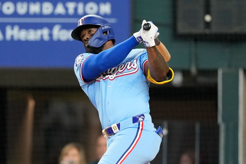 Apr 28, 2024; Arlington, Texas, USA; Texas Rangers right fielder Adolis Garcia (53) follows through on his two-run home run against the Cincinnati Reds during the first inning at Globe Life Field. Mandatory Credit: Jim Cowsert-USA TODAY Sports