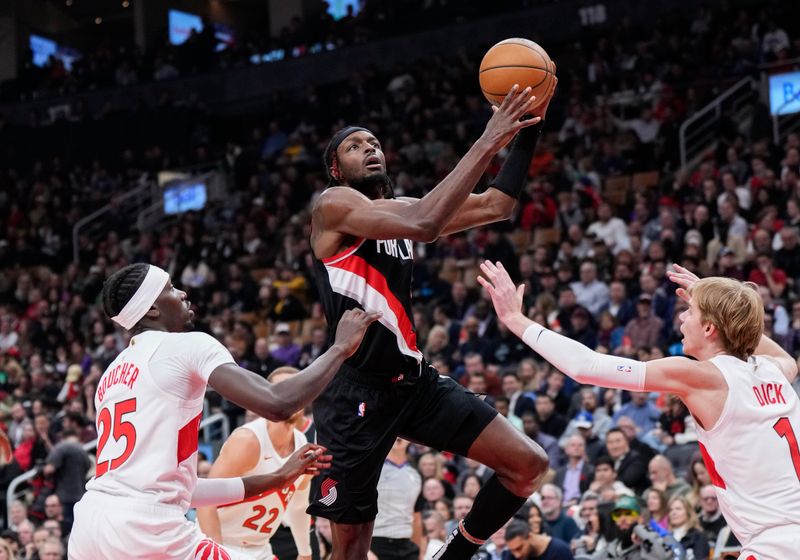 TORONTO, ON - OCTOBER 30: Jerami Grant #9 of the Portland Trail Blazers goes to the basket against Chris Boucher #25 and Gradey Dick #1 of the Toronto Raptors during the first half of their basketball game at the Scotiabank Arena on October 30, 2023 in Toronto, Ontario, Canada. NOTE TO USER: User expressly acknowledges and agrees that, by downloading and/or using this Photograph, user is consenting to the terms and conditions of the Getty Images License Agreement. (Photo by Mark Blinch/Getty Images)