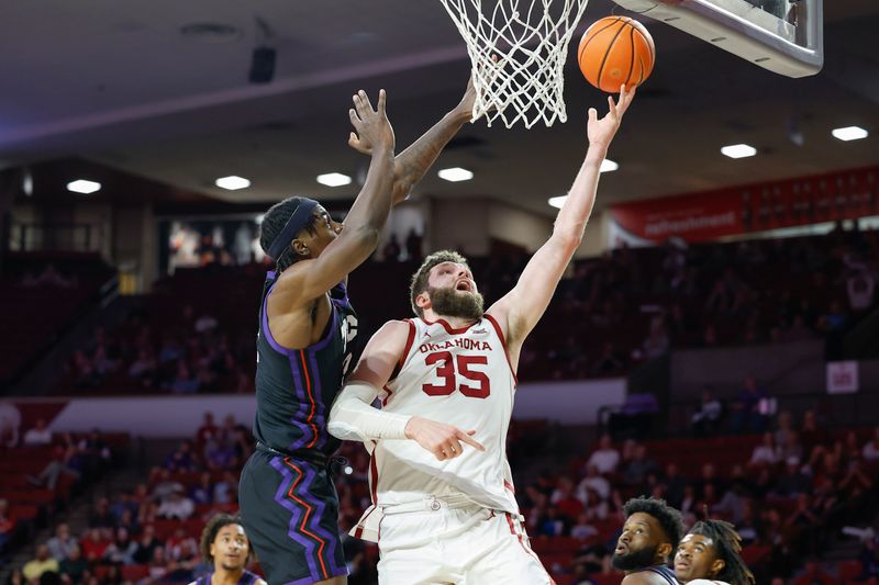 Mar 4, 2023; Norman, Oklahoma, USA; Oklahoma Sooners forward Tanner Groves (35) shoots the ball as TCU Horned Frogs forward Emanuel Miller (2) defends during the second half at Lloyd Noble Center. Oklahoma won 74-60. Mandatory Credit: Alonzo Adams-USA TODAY Sports