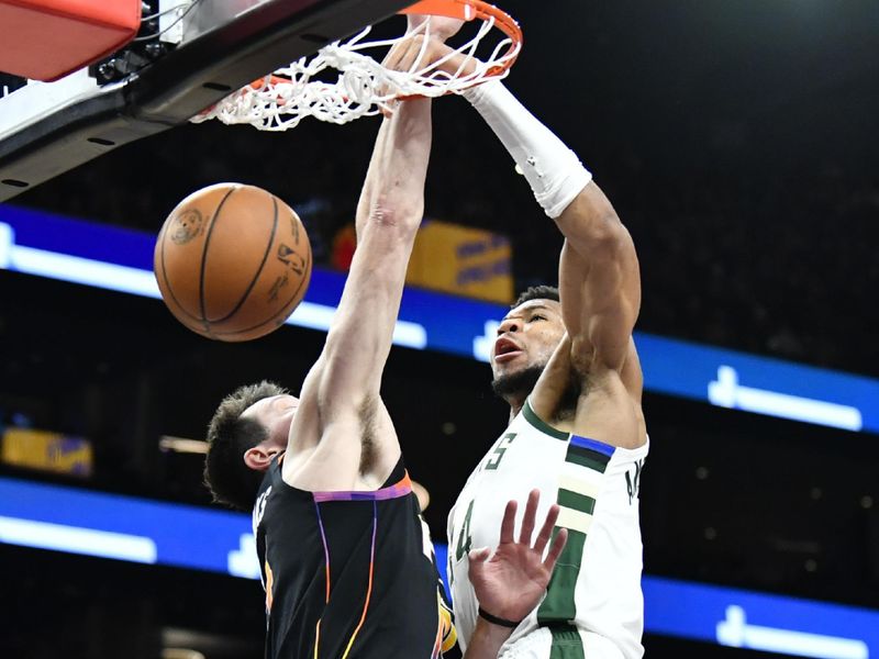 PHOENIX, ARIZONA - FEBRUARY 06: Giannis Antetokounmpo #34 dunks over Drew Eubanks #14 of the Phoenix Suns during the second half of the NBA game at Footprint Center on February 06, 2024 in Phoenix, Arizona. NOTE TO USER: User expressly acknowledges and agrees that, by downloading and or using this photograph, User is consenting to the terms and conditions of the Getty Images License Agreement.  (Photo by Kelsey Grant/Getty Images)