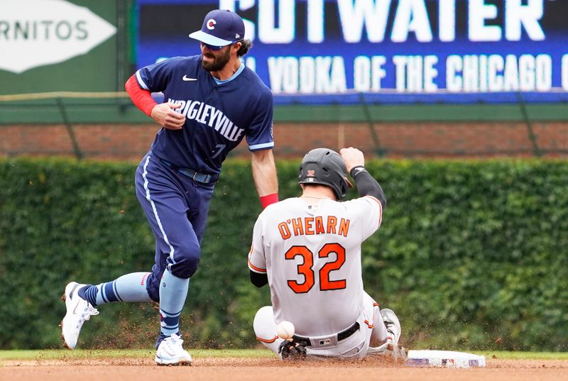 Jun 16, 2023; Chicago, Illinois, USA; Baltimore Orioles first baseman Ryan O'Hearn (32) gets hit by the ball as he runs to second base as Chicago Cubs shortstop Dansby Swanson (7) stands nearby during the second inning at Wrigley Field. Mandatory Credit: David Banks-USA TODAY Sports