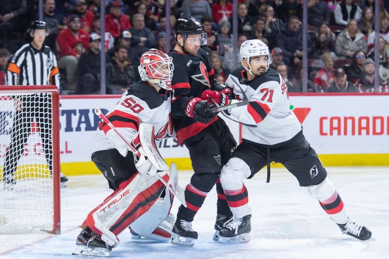 Dec 29, 2023; Ottawa, Ontario, CAN;  Ottawa Senators right wing Vladimir Tarasenko (91) jockeys for position between New Jersey Devils goalie Nico Daws (50) and defenseman Jonas Siegenthaler (71) in the first period at the Canadian Tire Centre. Mandatory Credit: Marc DesRosiers-USA TODAY Sports