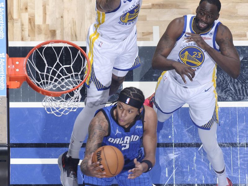 ORLANDO, FL - MARCH 27: Paolo Banchero #5 of the Orlando Magic drives to the basket during the game against the Golden State Warriors on March 27, 2024 at Amway Center in Orlando, Florida. NOTE TO USER: User expressly acknowledges and agrees that, by downloading and or using this photograph, User is consenting to the terms and conditions of the Getty Images License Agreement. Mandatory Copyright Notice: Copyright 2024 NBAE (Photo by Fernando Medina/NBAE via Getty Images)