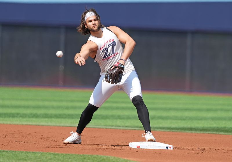 Sep 4, 2024; Toronto, Ontario, CAN; Toronto Blue Jays shortstop Bo Bichette (11) throws a ball to first base during batting practice before game against the Philadelphia Phillies at Rogers Centre. Mandatory Credit: Nick Turchiaro-Imagn Images